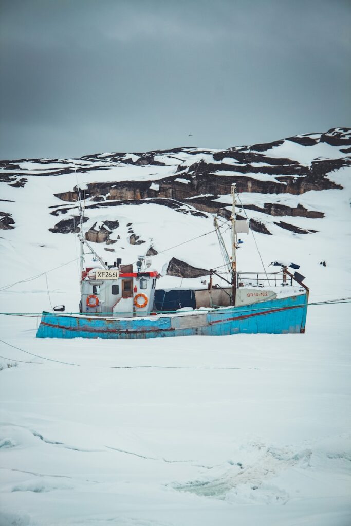 A fishing boat in the middle of a snowy field